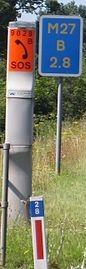 Driver Location Sign, Emergency Telephone and Location Marker Post on a motorway verge